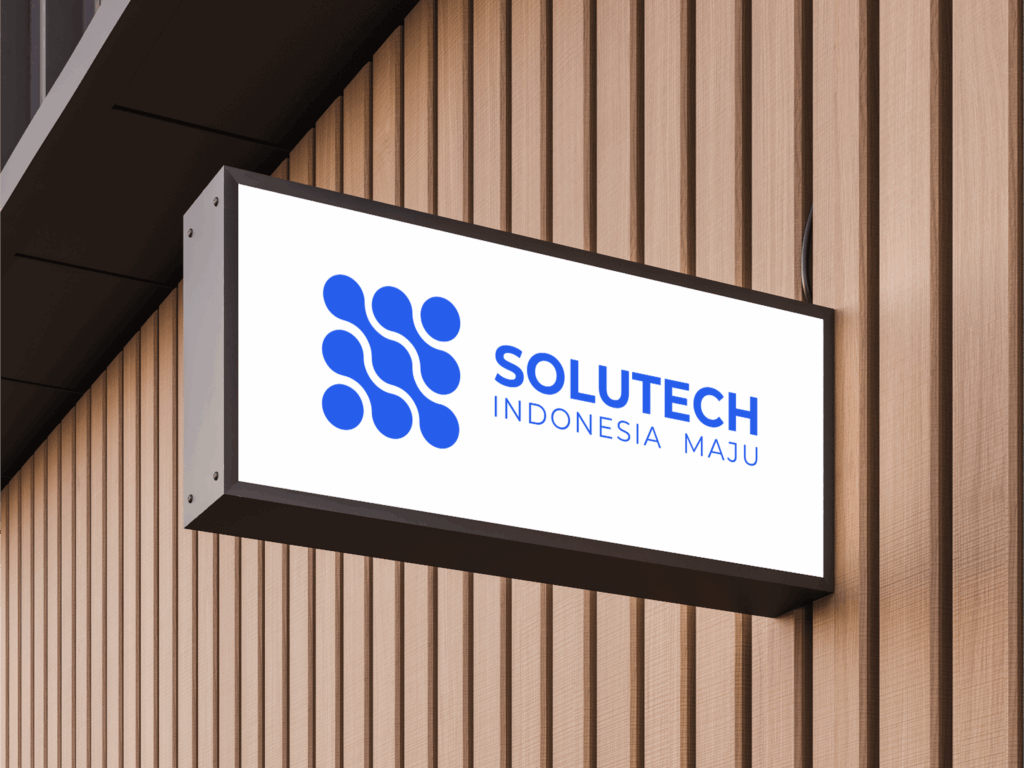 About 1 Papan nama toko tertempel di samping dinding dengan logo dan teks Solutech Indonesia Maju yang mengutamakan inovasi teknologi